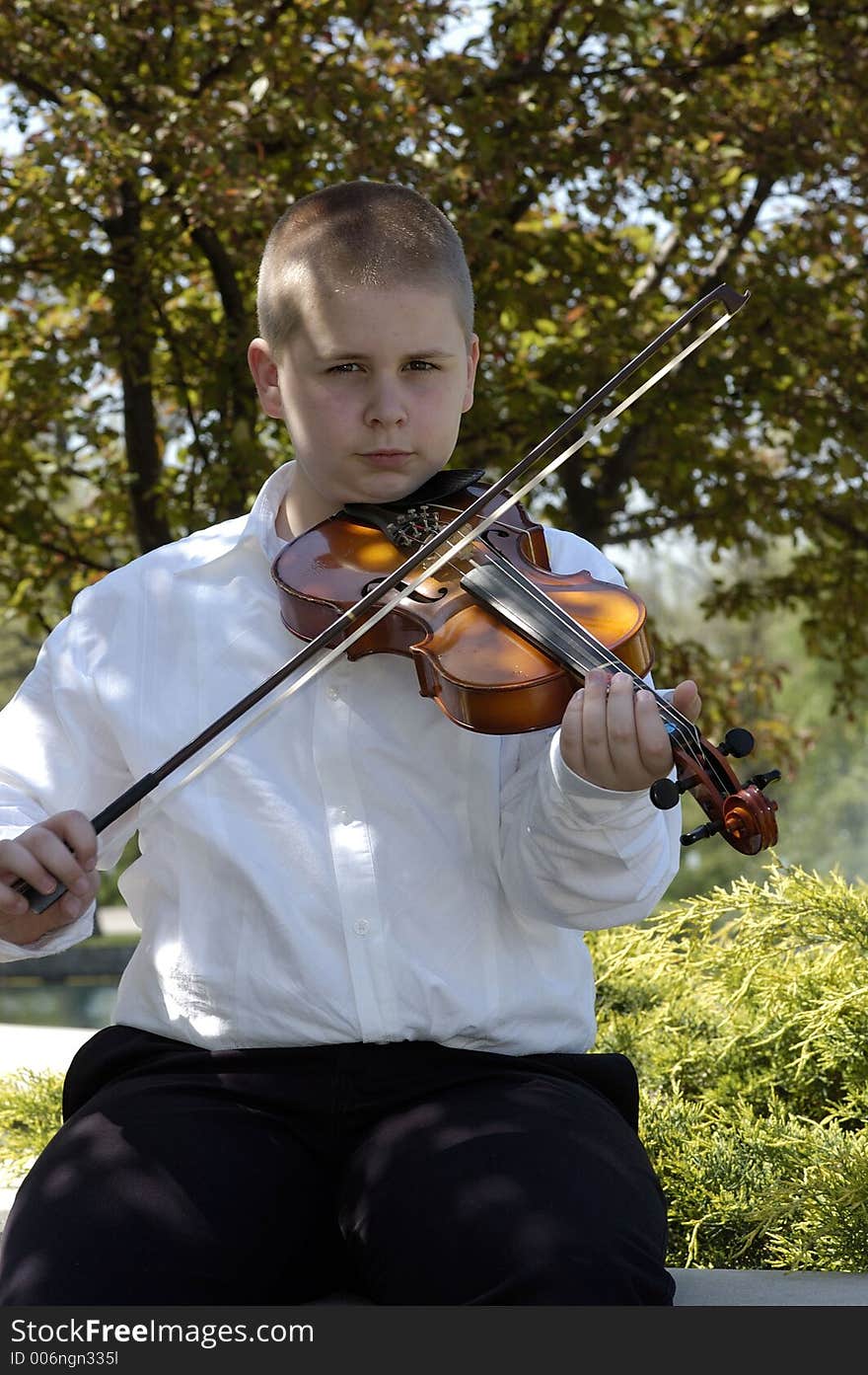 Boy Sitting Outside Playing Viola