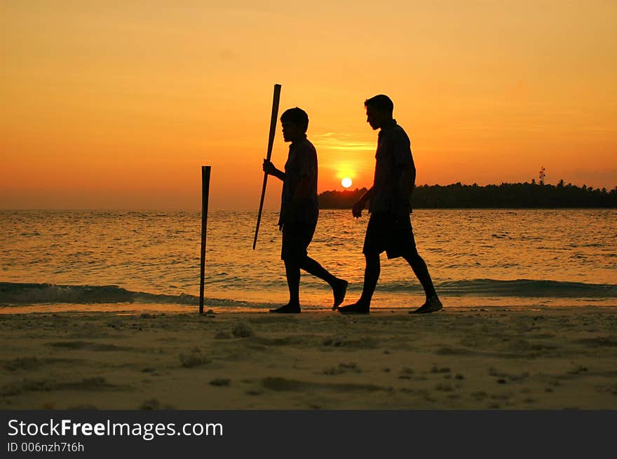 Two boys walking on a sunset. Two boys walking on a sunset