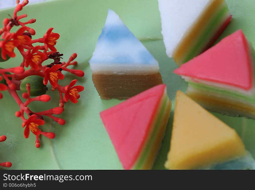 Sweet and colorful layer cakes displayed in green plate. Sweet and colorful layer cakes displayed in green plate