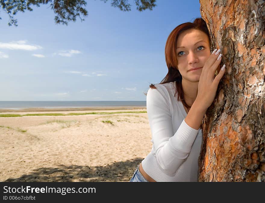 Girl on a beach in a shadow of a tree-2