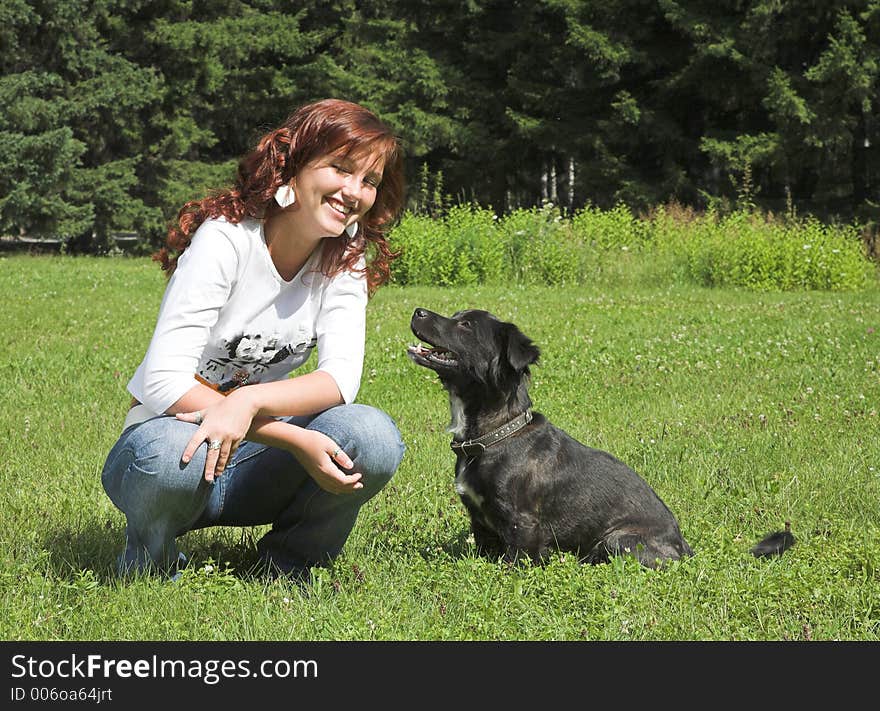 Beautiful girl wiht dog in summer day