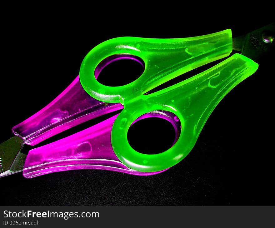 Two colorful scissors on black. Two colorful scissors on black