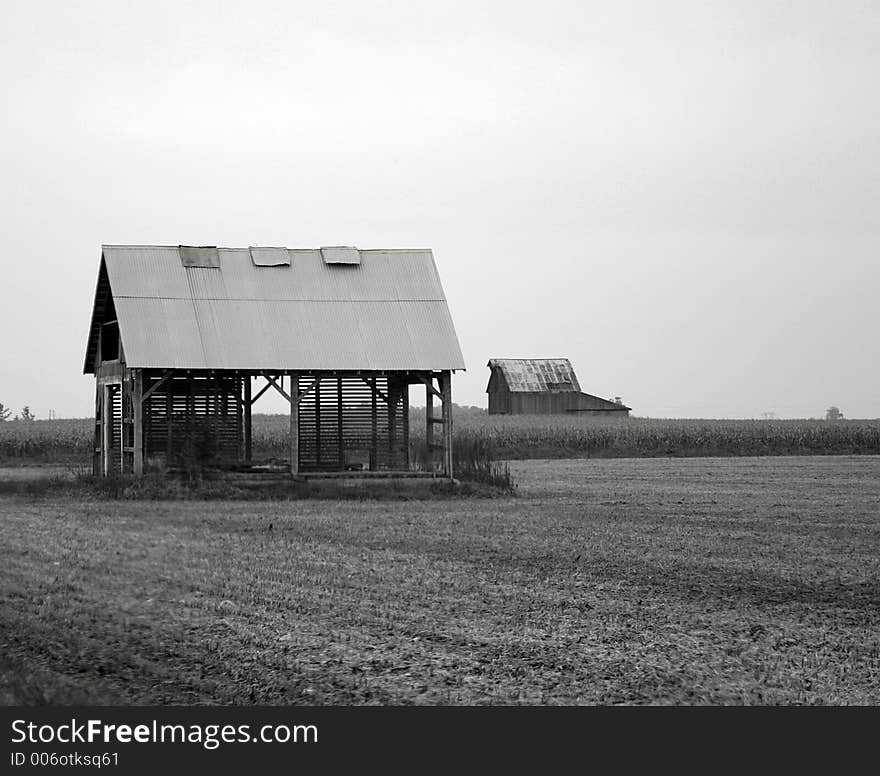 Black and white image of a dilapidated farm building. Black and white image of a dilapidated farm building