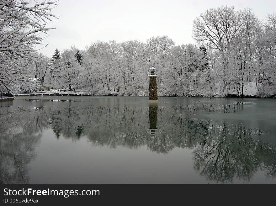 Lighthouse on calm winter pond. Lighthouse on calm winter pond.