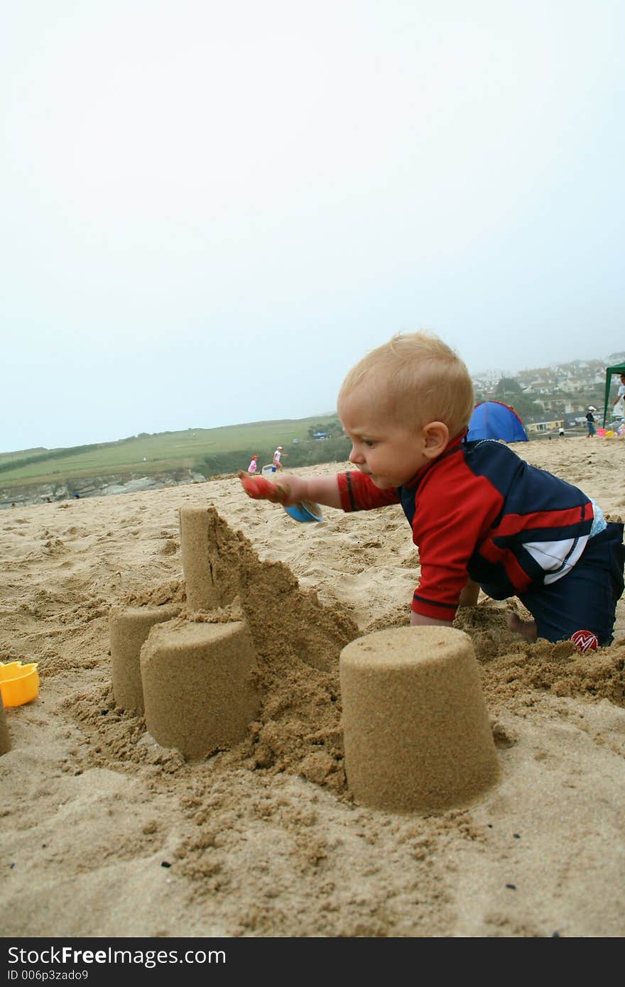 Small child exploring a beach in Cornwall. Small child exploring a beach in Cornwall.