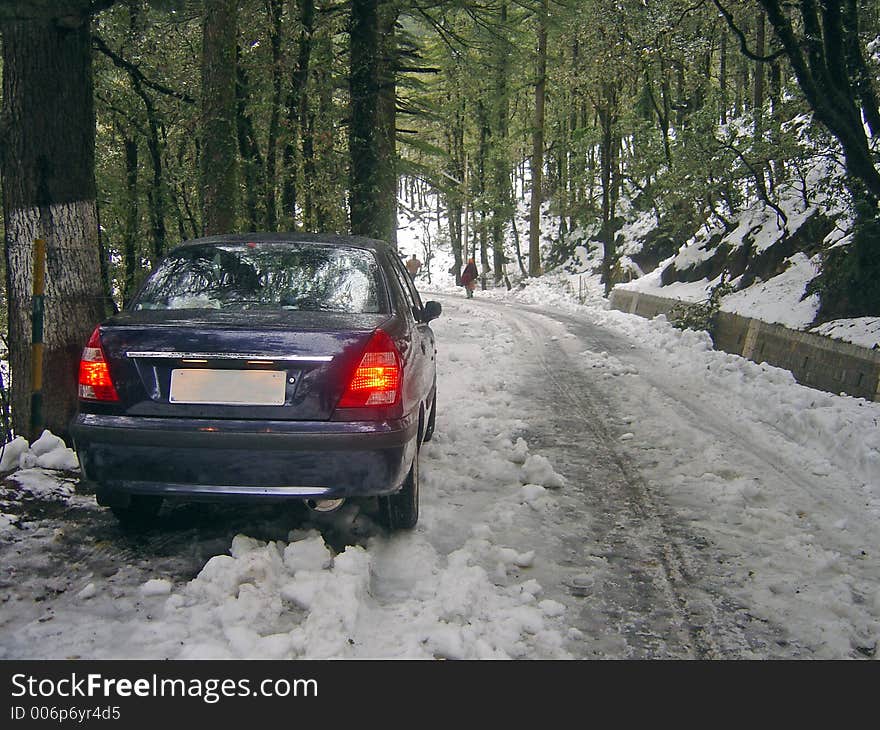 car stuck in slippery snow on steep mountain road. car stuck in slippery snow on steep mountain road