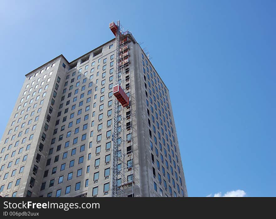 High Building with external lifts for temporary construction. High Building with external lifts for temporary construction