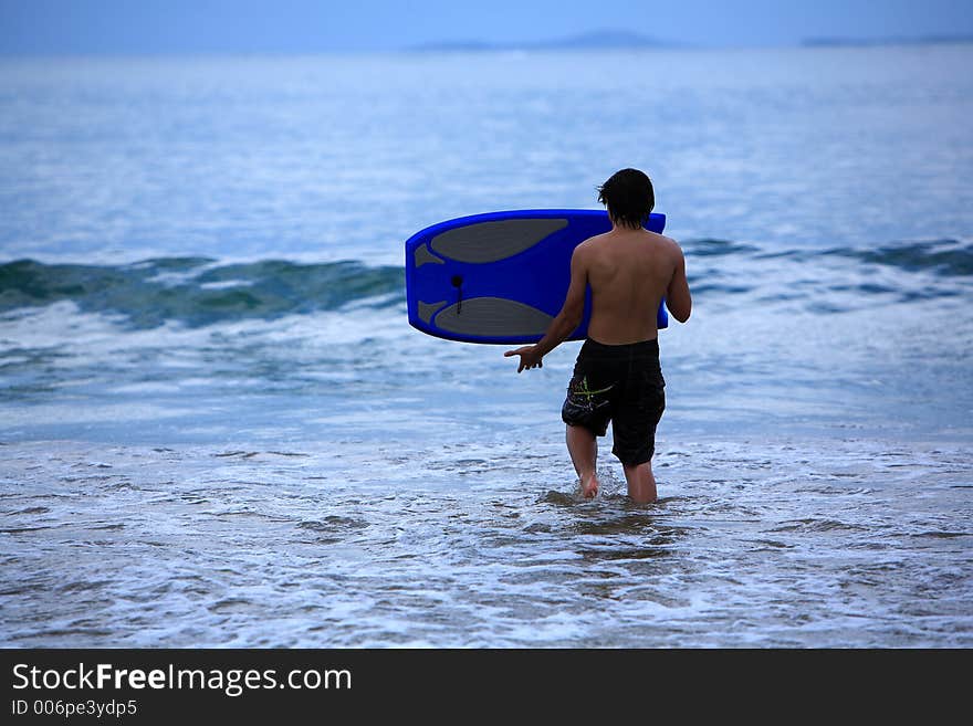 Young man going to surf. Young man going to surf