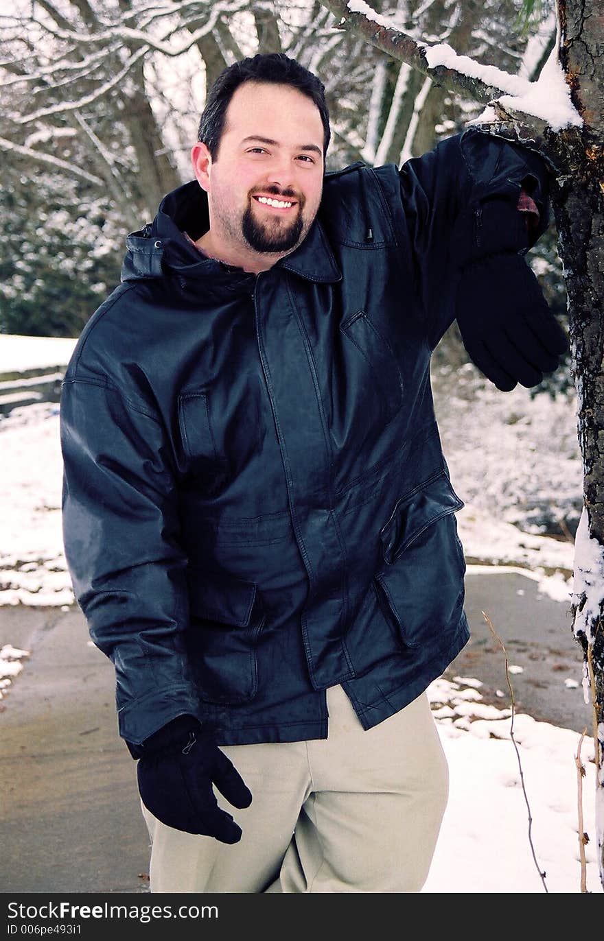 Handsome male posing outdoors in the snow. Handsome male posing outdoors in the snow.