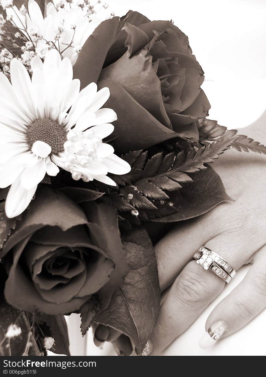 Bride s wedding ring hand and bouquet closeup sepia