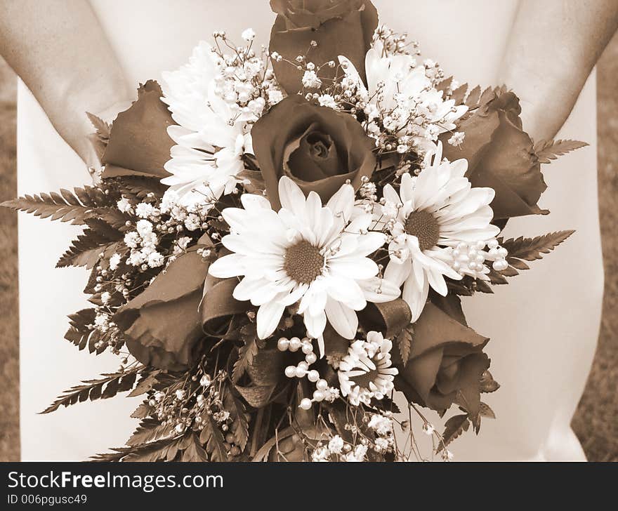 Bride Holding Her Wedding Bouquet Against Her Dress - Horizontal