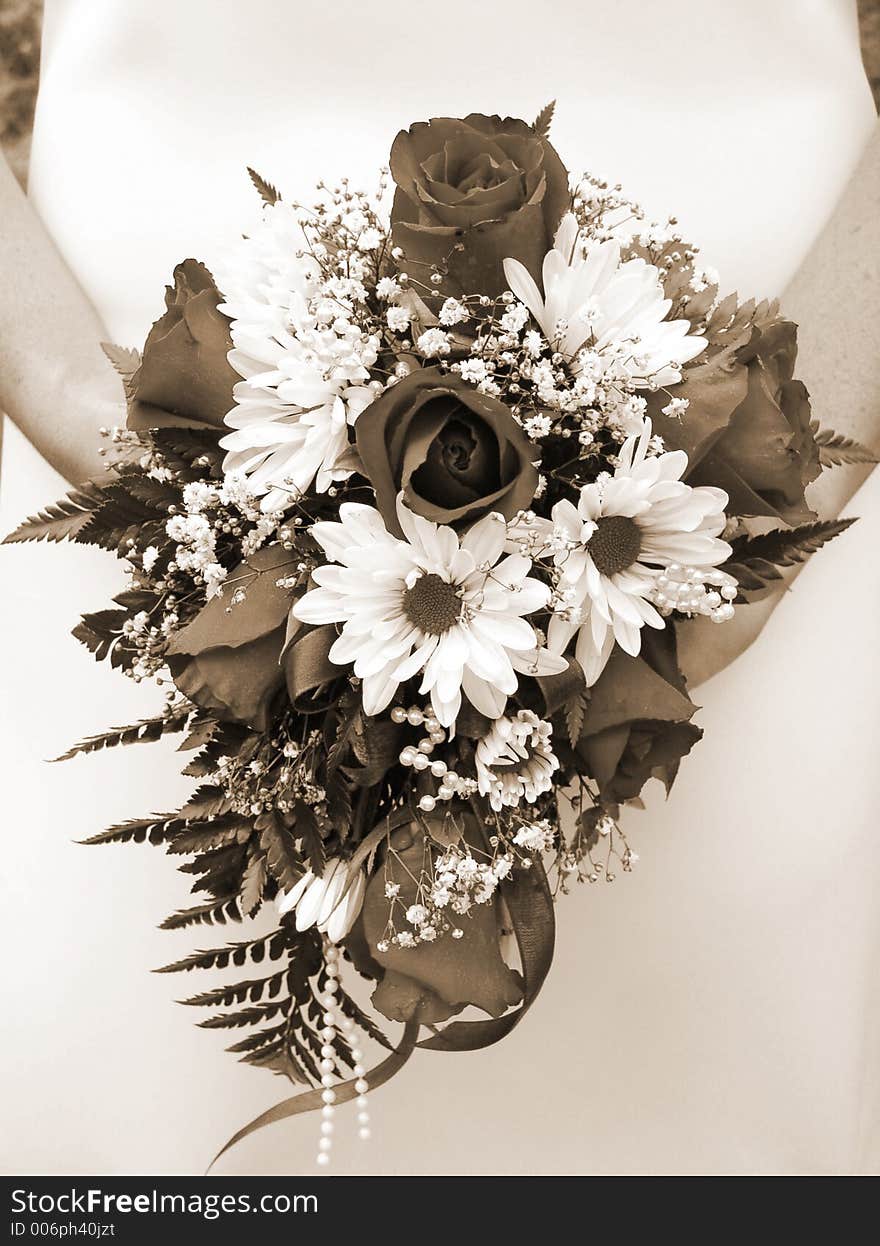 Bride Holding Her Wedding Bouquet Against Her Dress