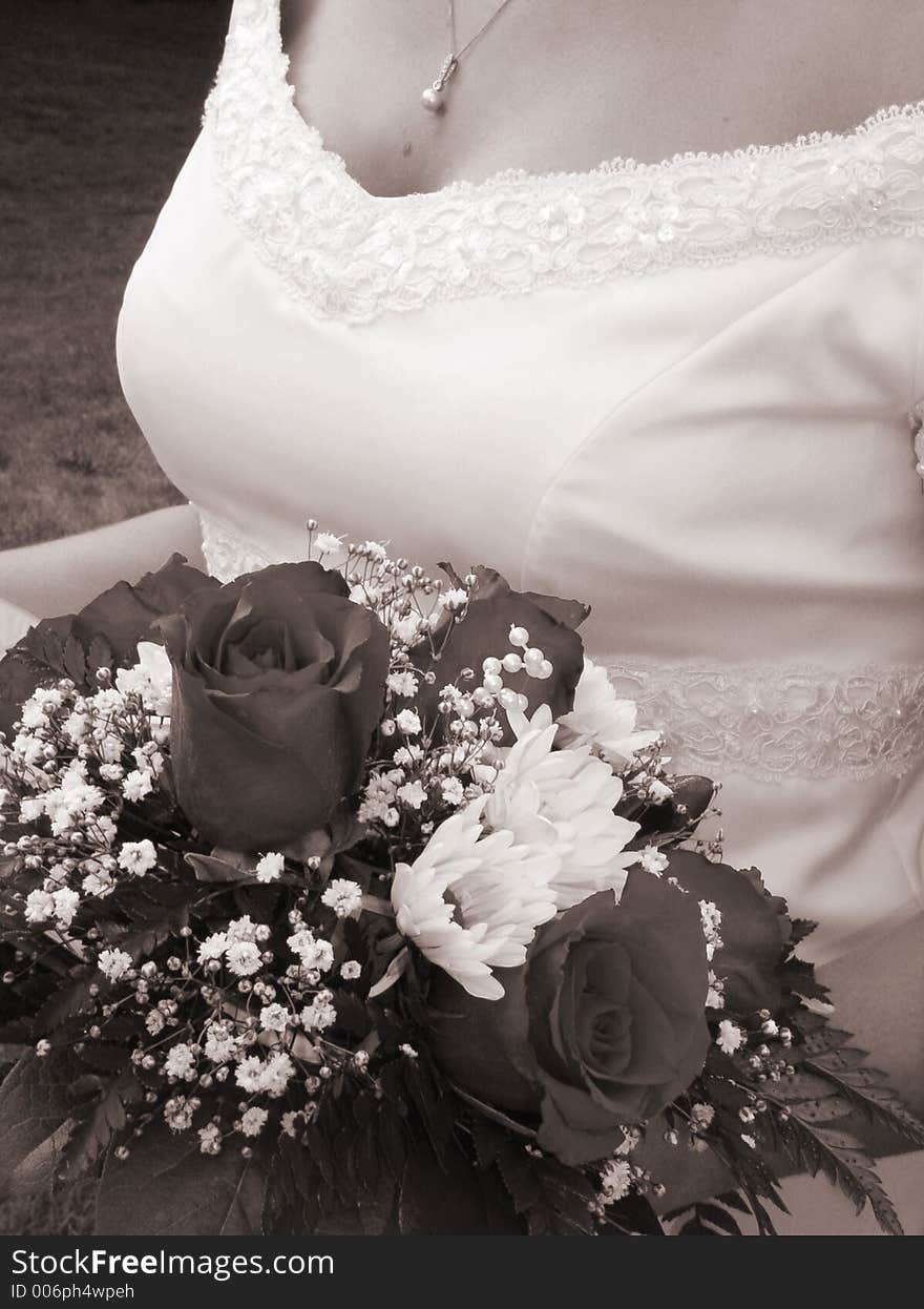 Wedding bouquet and bride's bust in sepia