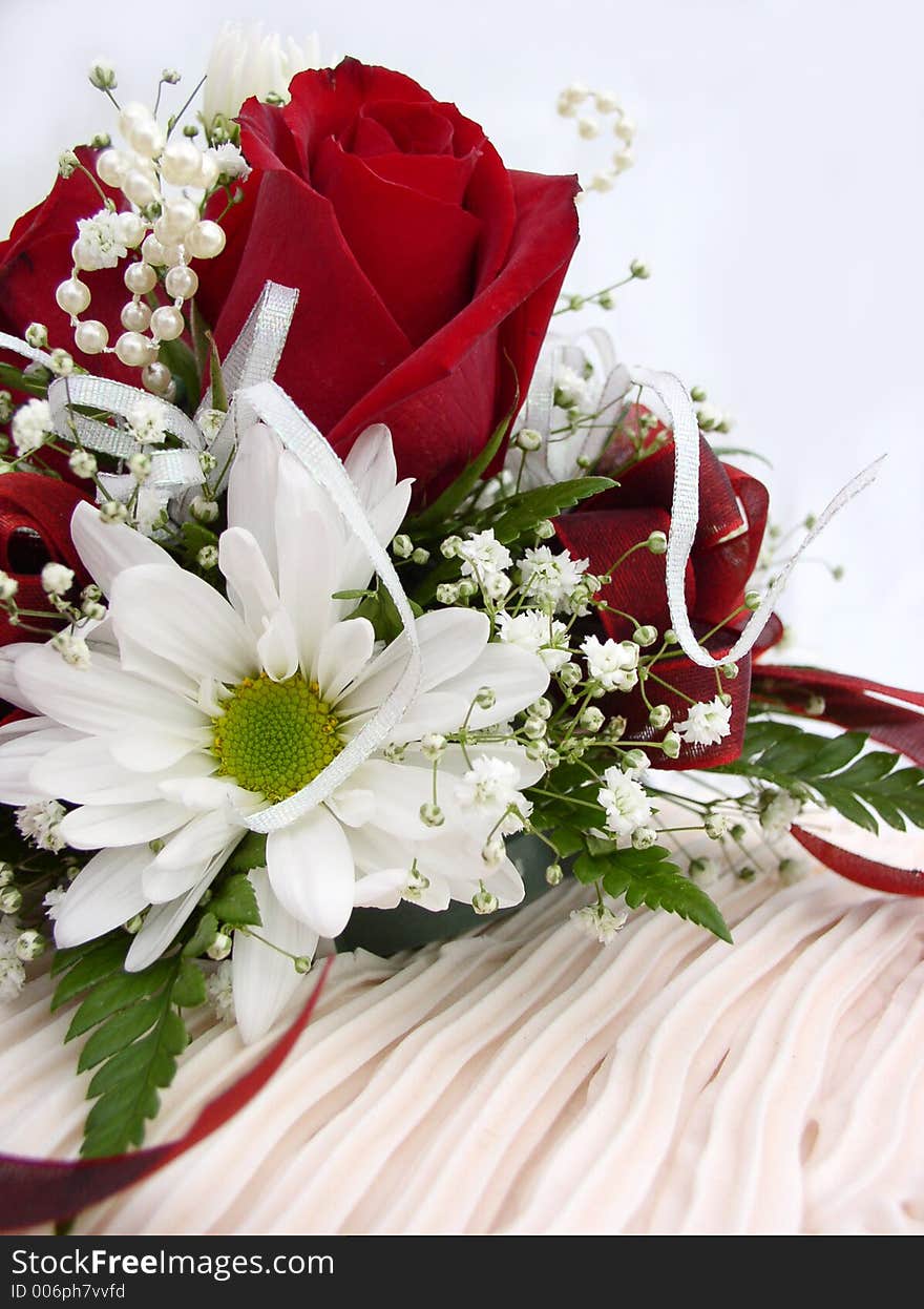 Red roses and flowers atop wedding cake. Red roses and flowers atop wedding cake