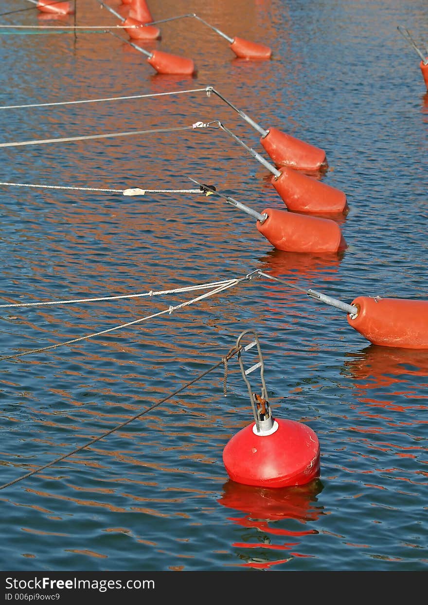 Yacht fixing buoys in a wharf before sunset