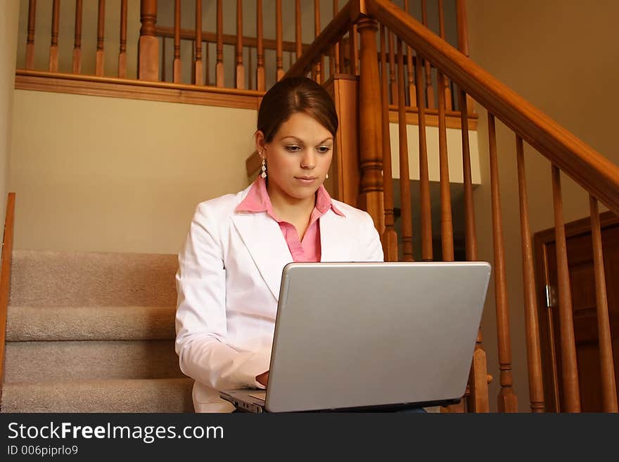 Business woman working at home on her laptop