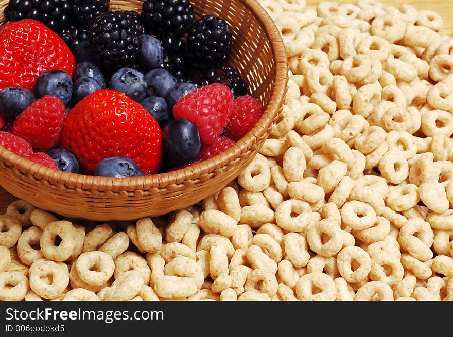 Bowl with forest fruits (blueberries,strawberries, blackberries) against cereals. Bowl with forest fruits (blueberries,strawberries, blackberries) against cereals.