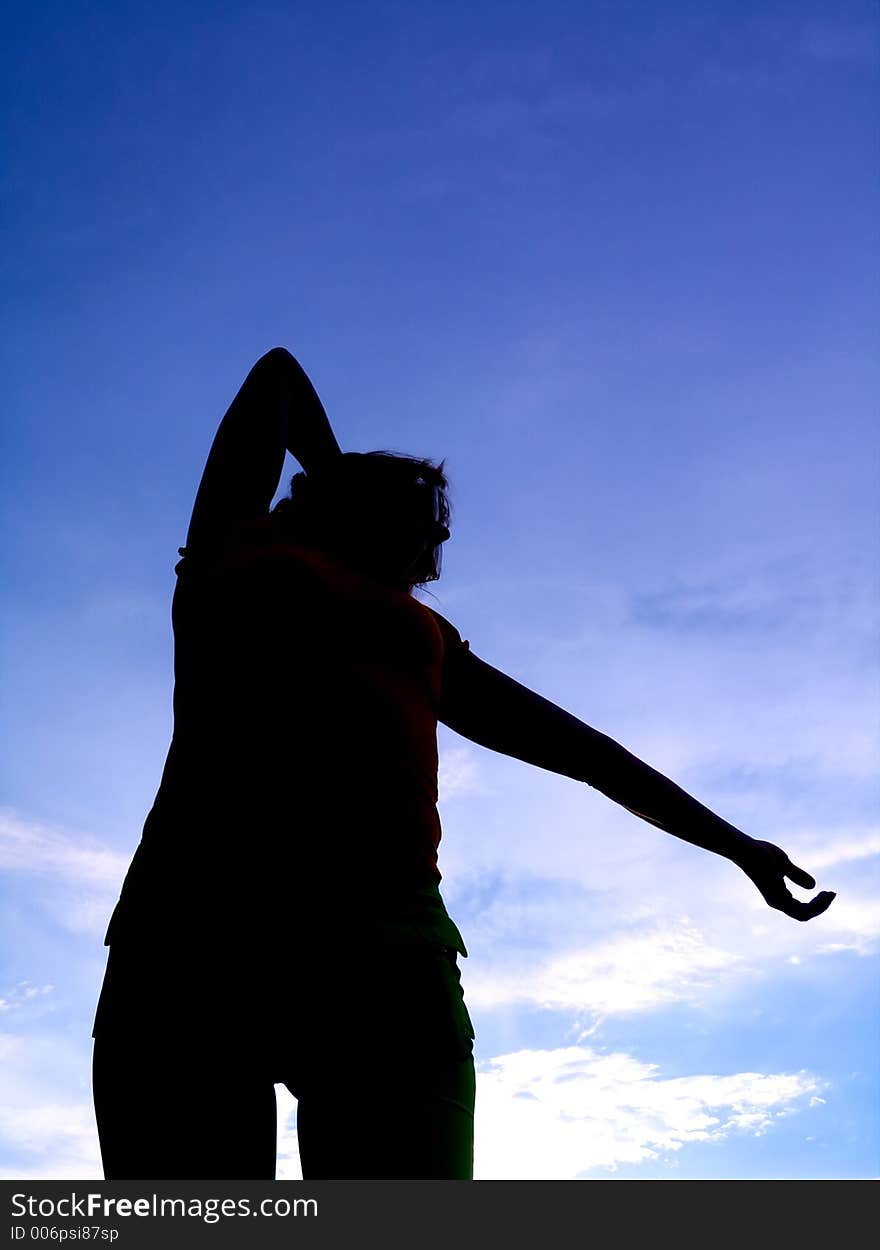 Feminine silhouette on background sky