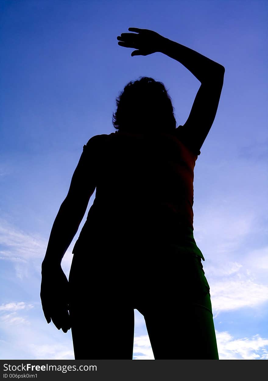 Feminine silhouette on background sky