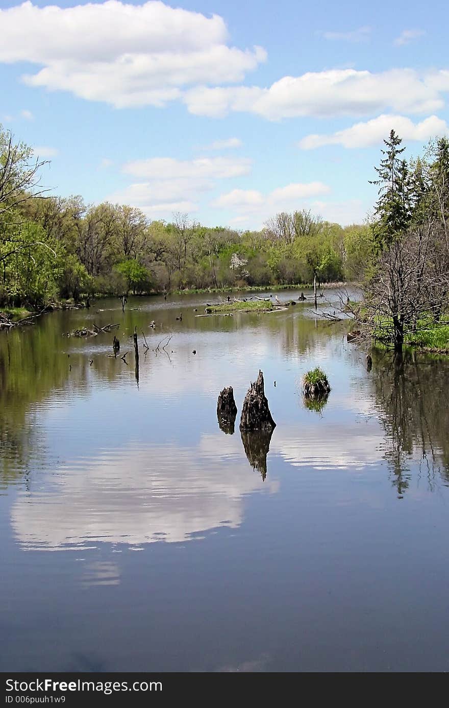 Creek in spring, reflection of sky and clouds in water. Creek in spring, reflection of sky and clouds in water