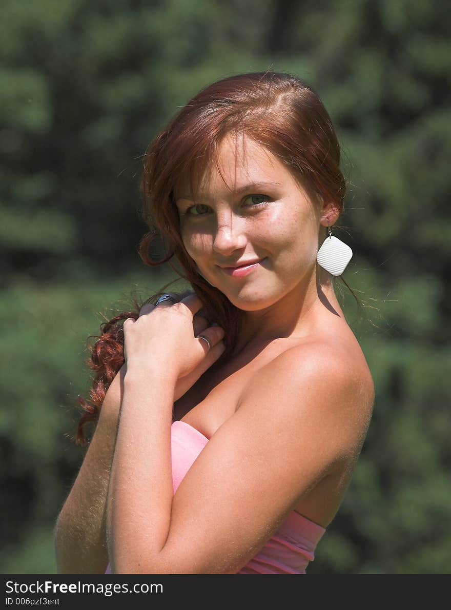 Beautiful girl in pink dress in summer day