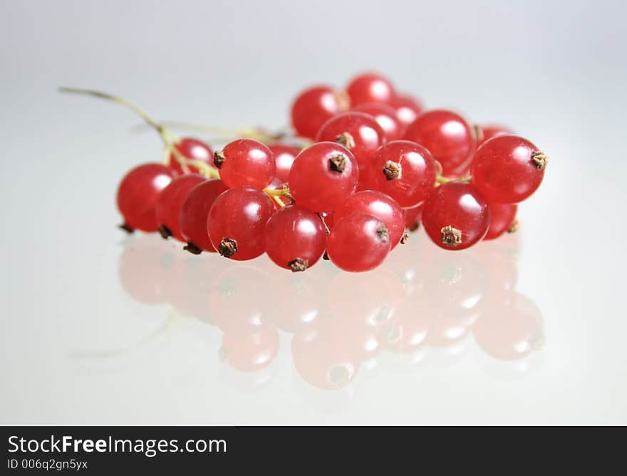 Red currants on a glass table