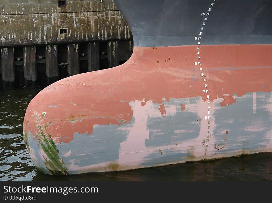 Draft marks and weathered paint at ship hull