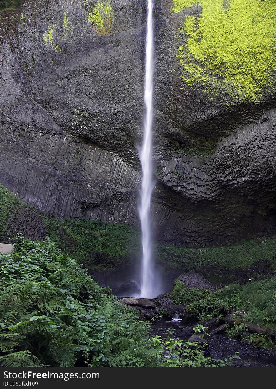 Latourell Falls in the Columbia River Gorge plunges 249 feet over a cliff of volcanic columnar basalt before flowing into the Columbia River near Portland, Oregon USA.