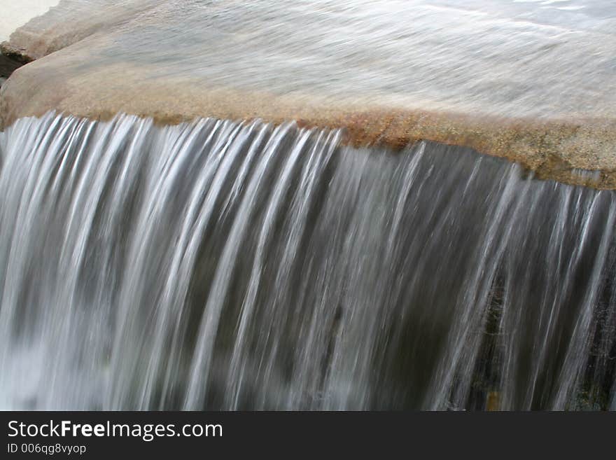 Water flowing down from a rock in a small park in Oslo. Water flowing down from a rock in a small park in Oslo