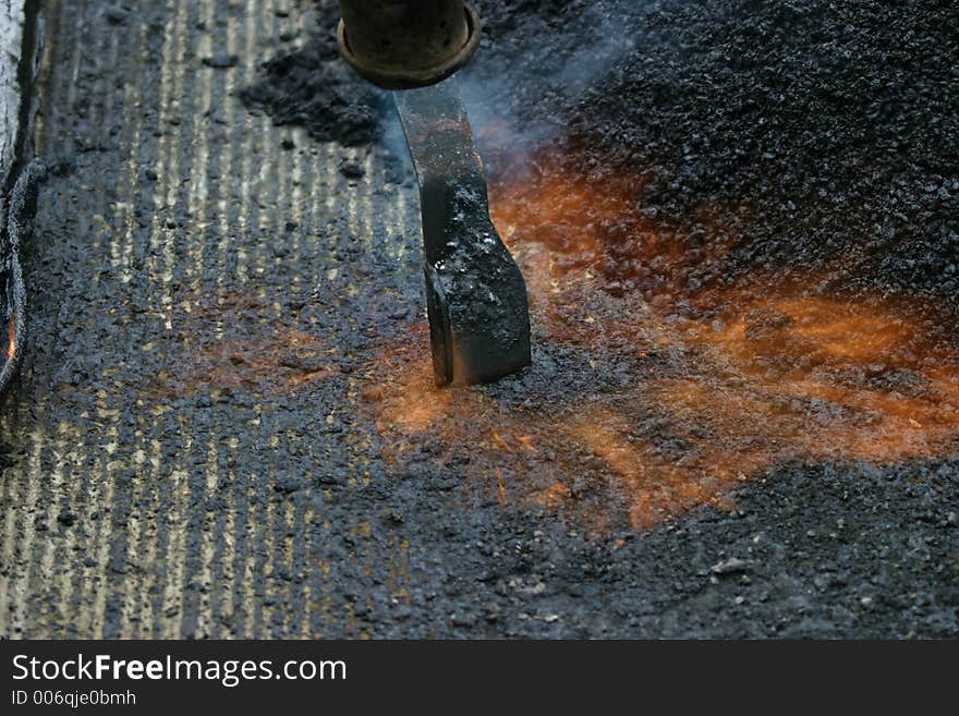 Preparing a road for a new tar layer. Preparing a road for a new tar layer