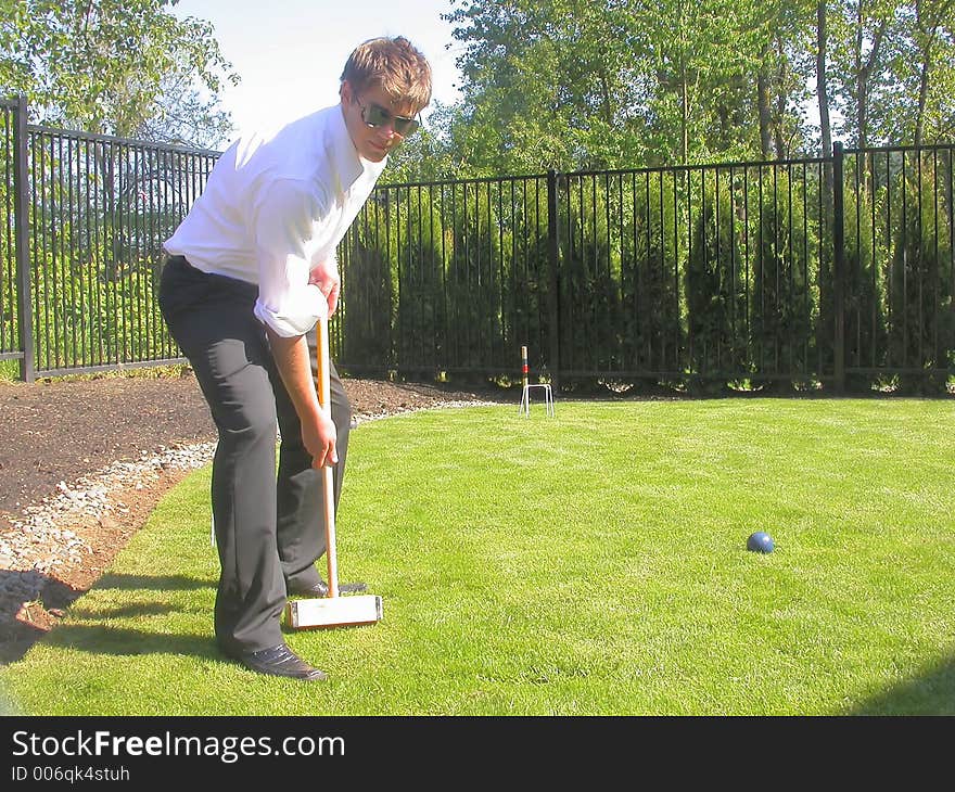 Jonny playing a casual game of back yard croquet...showing off for the camera,. Jonny playing a casual game of back yard croquet...showing off for the camera,