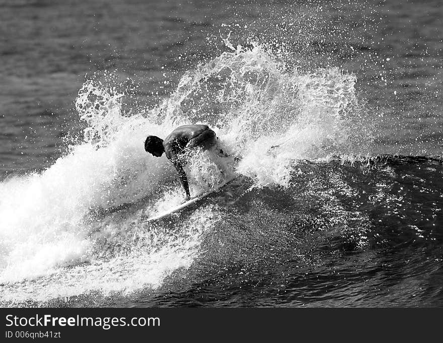 A surfer does a backside spray while surfing in Honolulu, Hawaii. A surfer does a backside spray while surfing in Honolulu, Hawaii.