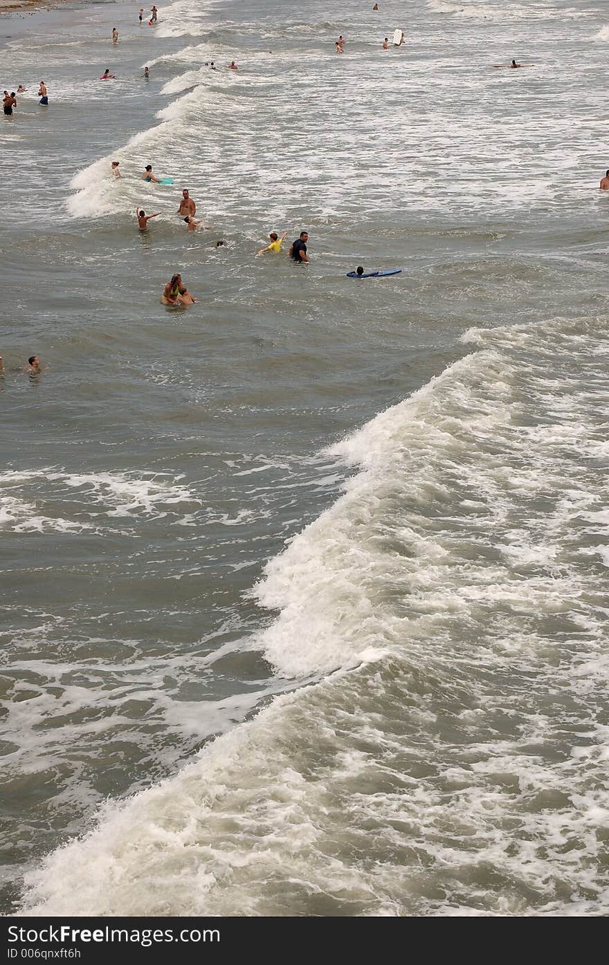 Swimmers at Folly Beach near Charleston, SC jumping in the waves. Swimmers at Folly Beach near Charleston, SC jumping in the waves.