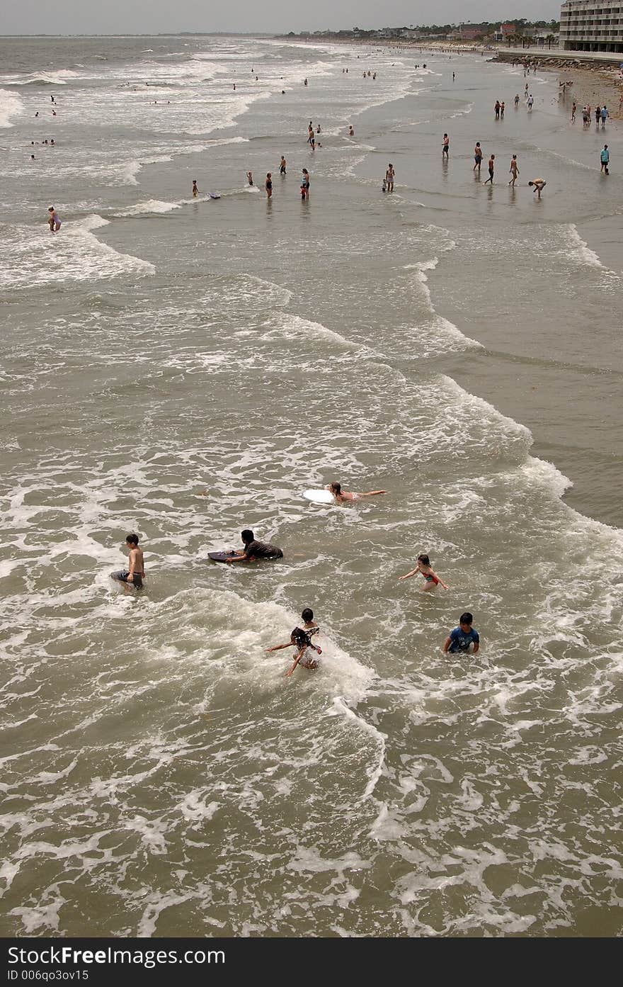 Swimmers at Folly Beach near Charleston, SC jumping in the waves. Swimmers at Folly Beach near Charleston, SC jumping in the waves.