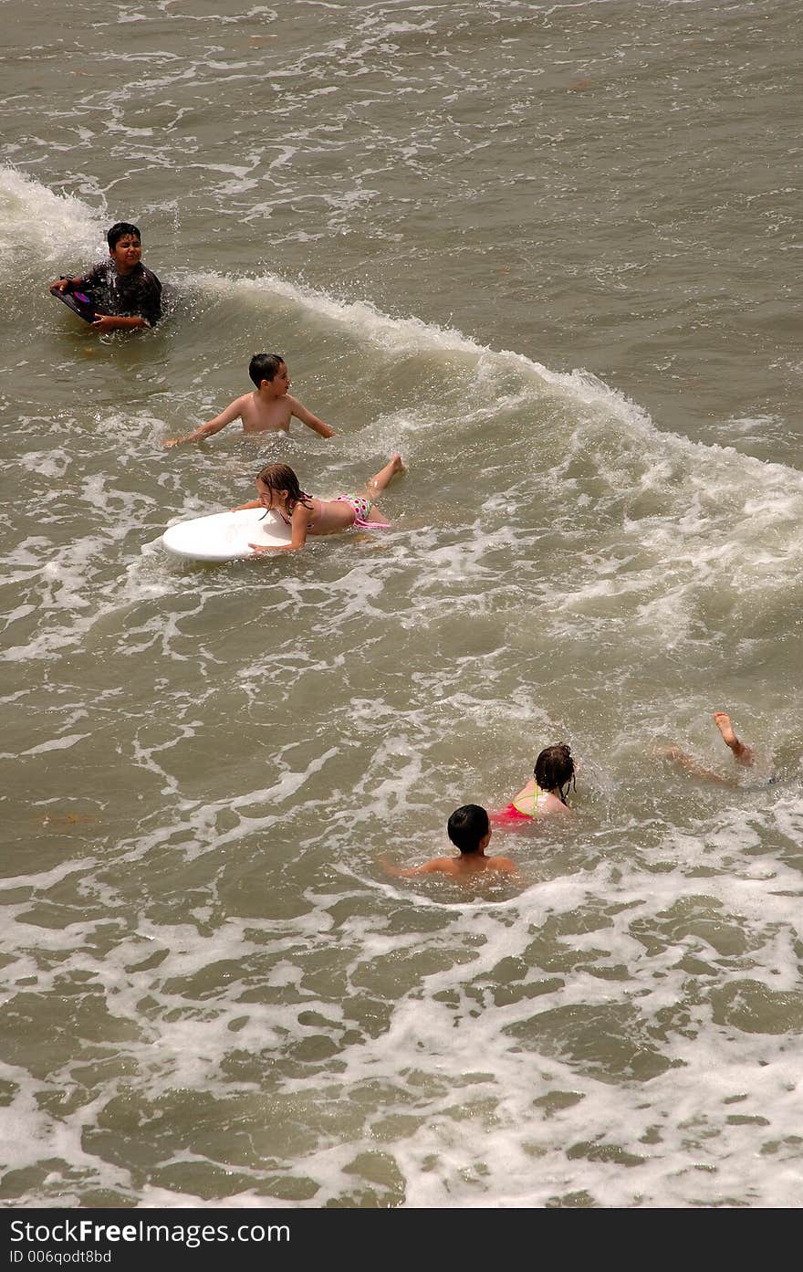 Swimmers at Folly Beach near Charleston, SC jumping in the waves. Swimmers at Folly Beach near Charleston, SC jumping in the waves.