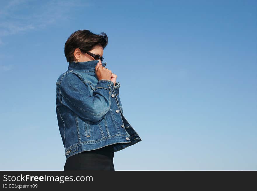 Woman hiding in her wind-breaker of Jean. Woman hiding in her wind-breaker of Jean