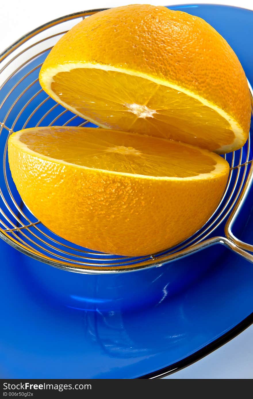 Half of orange on a blue plate