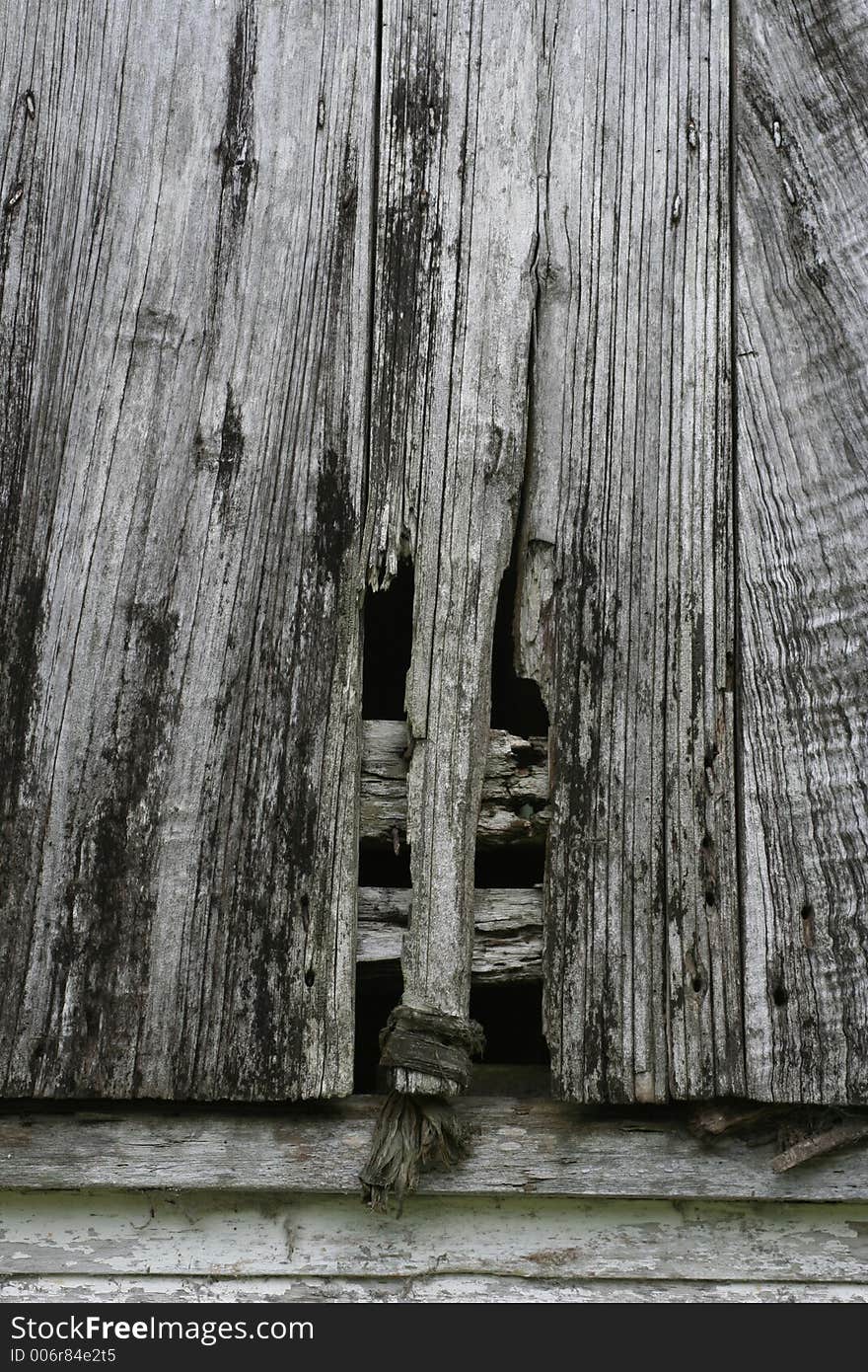 Boards of and old window rot with neglect. Boards of and old window rot with neglect