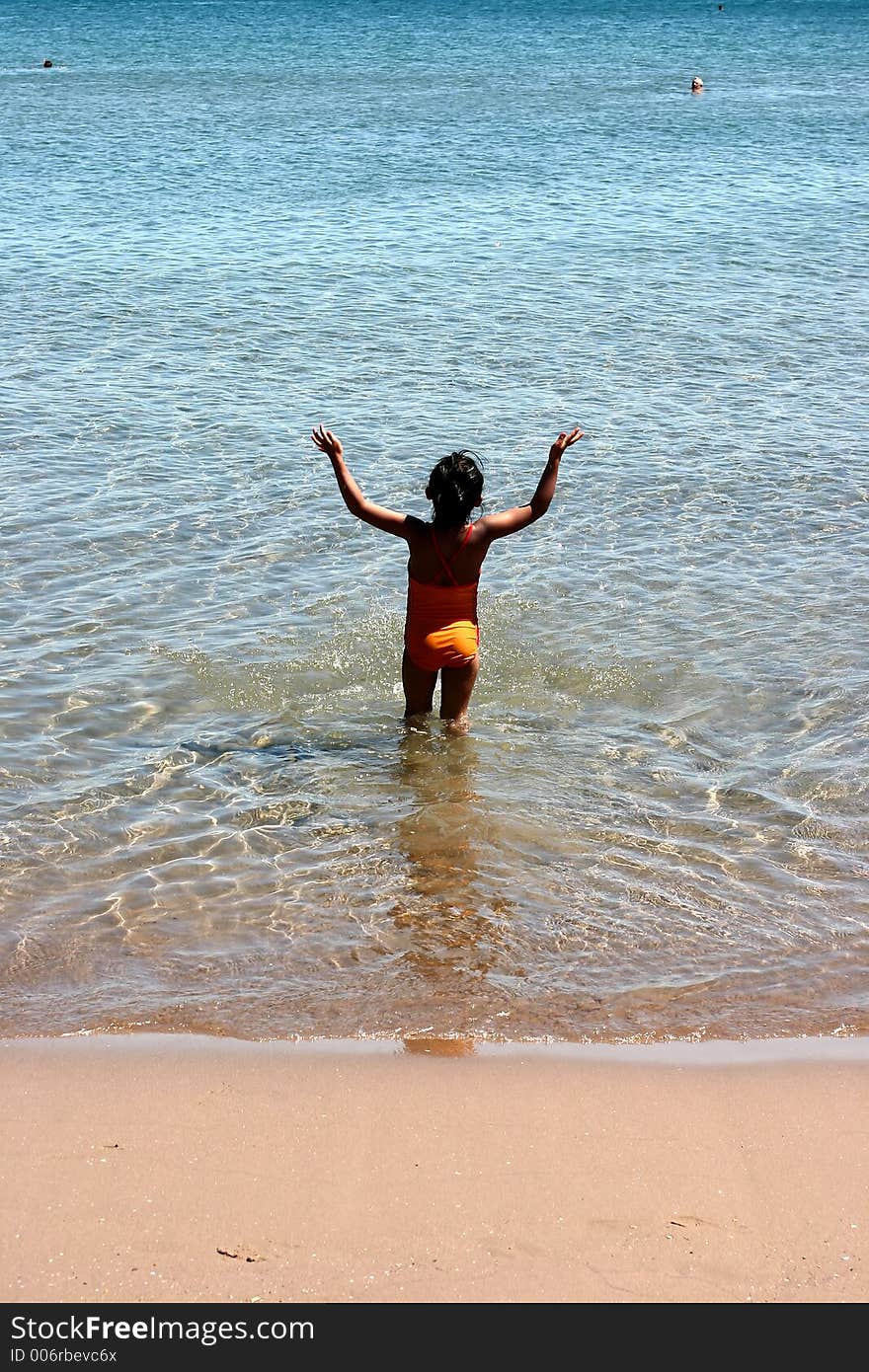 Corsica   Bay of Calvi, child on the beach entering into the water ,. Corsica   Bay of Calvi, child on the beach entering into the water ,