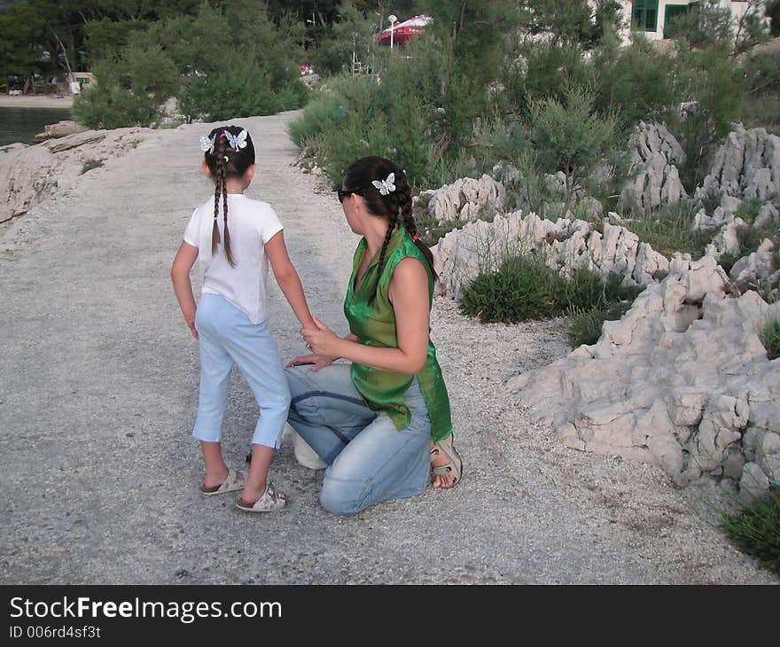 A little girl and her mum with silver butterflies in the hair. Photo taken im Makarska, a summer holiday resort in Croatia.