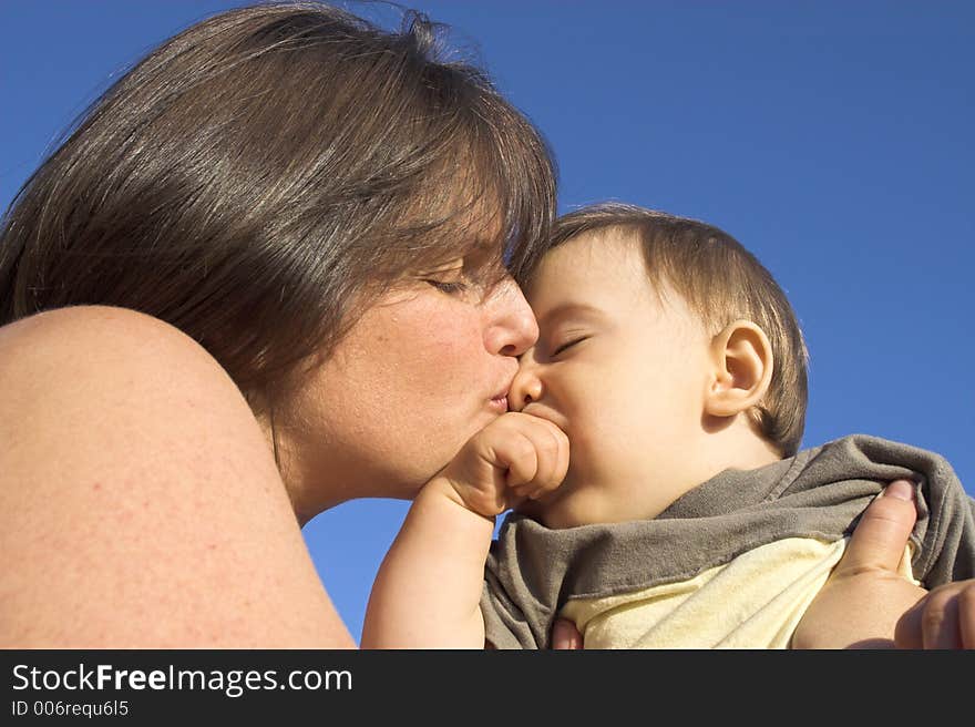 Mother and son over blue sky