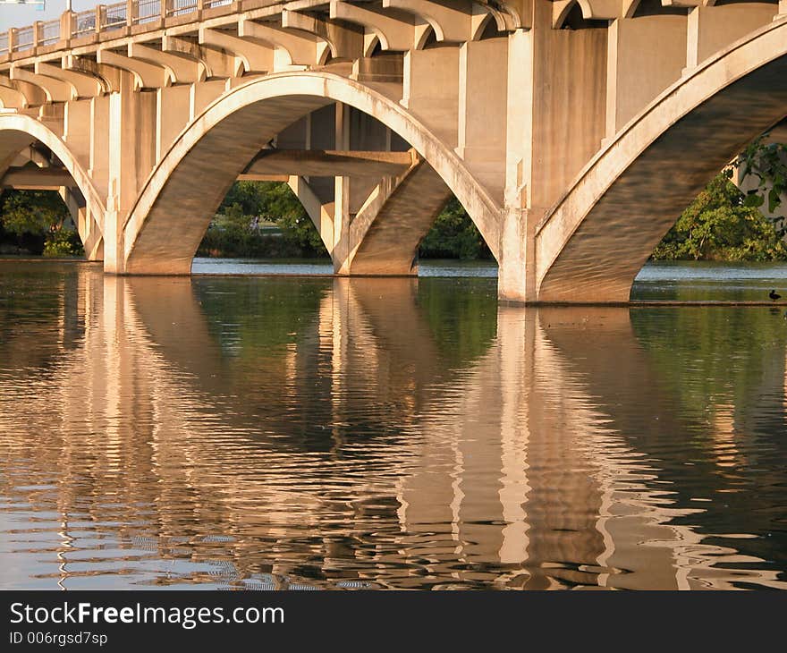 This bridge devides Austin into South Austin and North Austin. It was taken at sunset. You can see its majestic reflection on the water. This bridge devides Austin into South Austin and North Austin. It was taken at sunset. You can see its majestic reflection on the water.