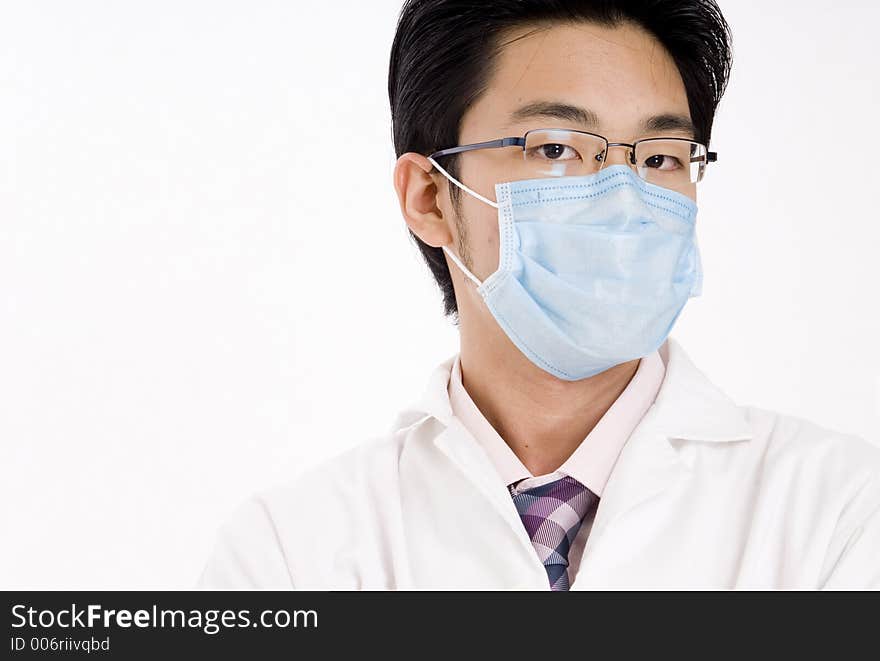 A young asian man in blue face mask and white coat