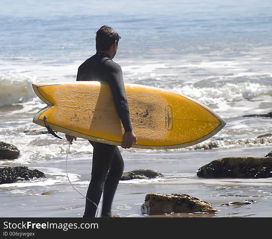 Male surfer looking for the right wave.