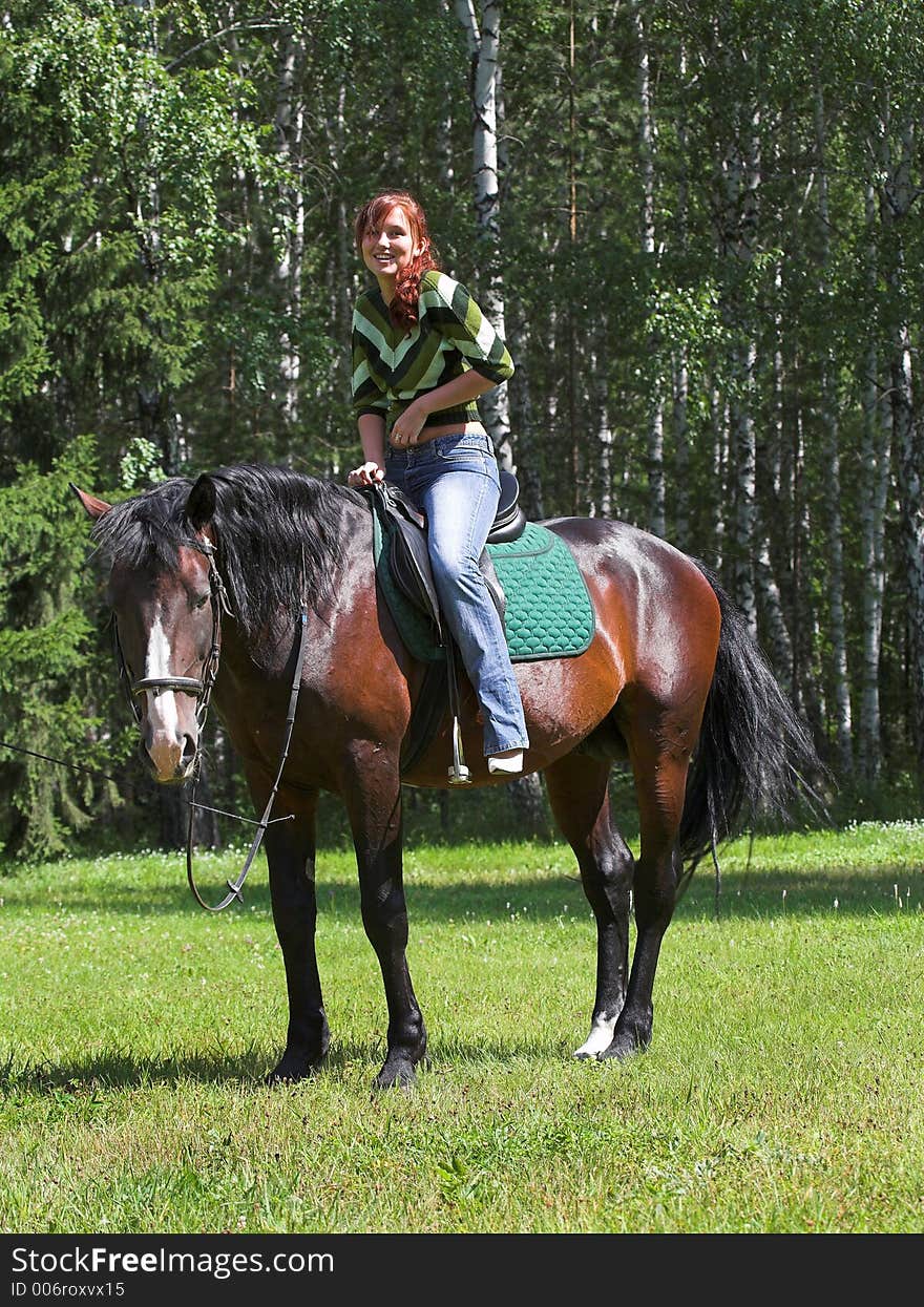 Girl on chestnut horse in summer day. Girl on chestnut horse in summer day