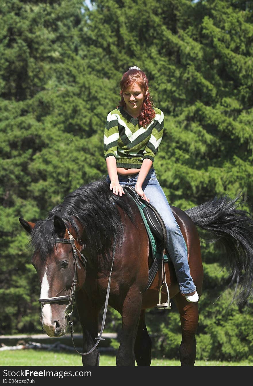 Girl on chestnut horse in summer day. Girl on chestnut horse in summer day