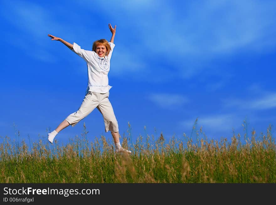 Beauty girl in field under clouds