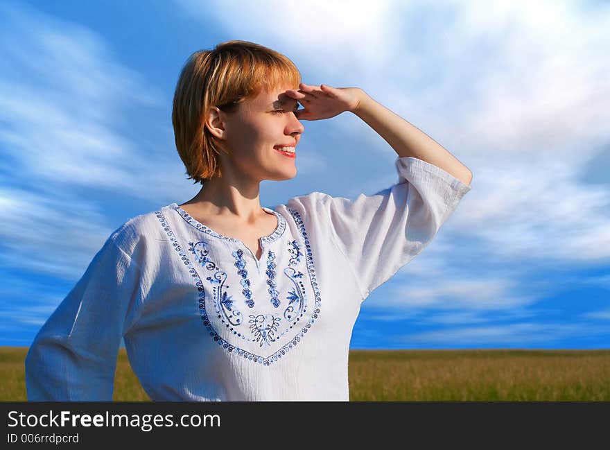 Beauty Girl In Field Under Clouds