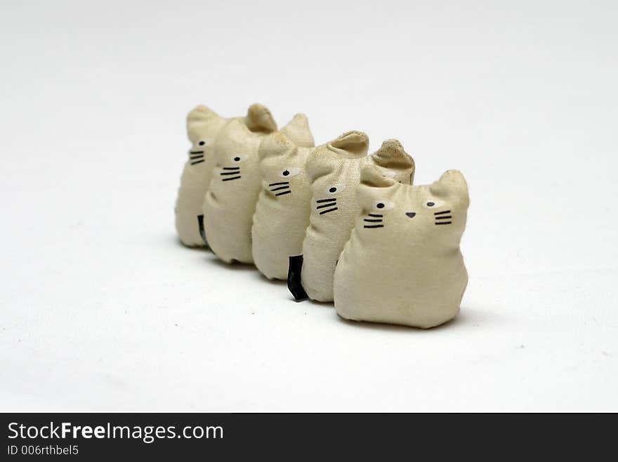 Bean Stuffed toy cats standing in a line - This is set of Five-Stones, a popular game that children in south east asia plays.