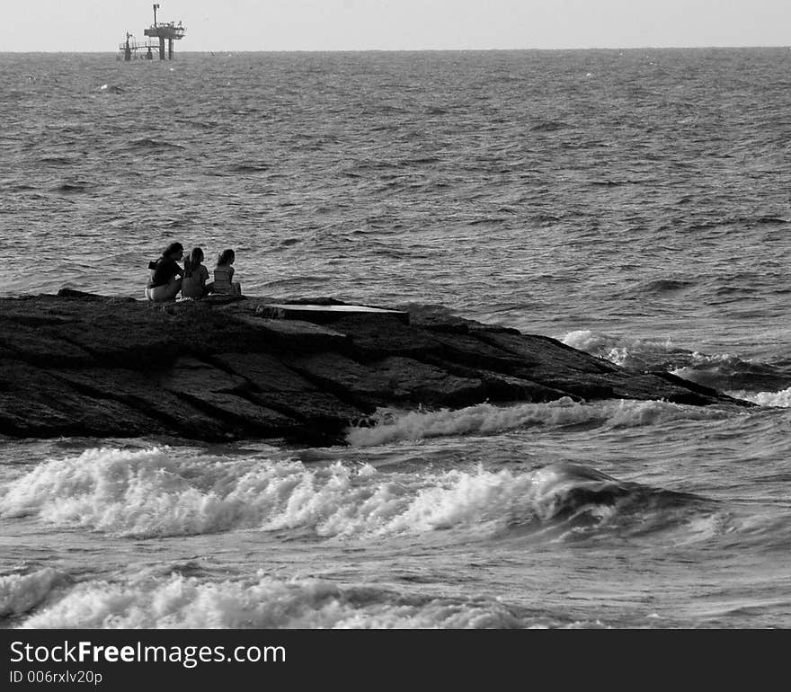 Girls on a jetty looking out onto the  Gulf of Mexico. Girls on a jetty looking out onto the  Gulf of Mexico